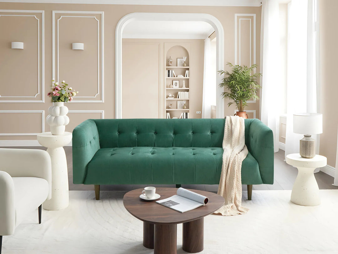 Modern living room with a green sofa, wooden coffee table, and decorative elements.