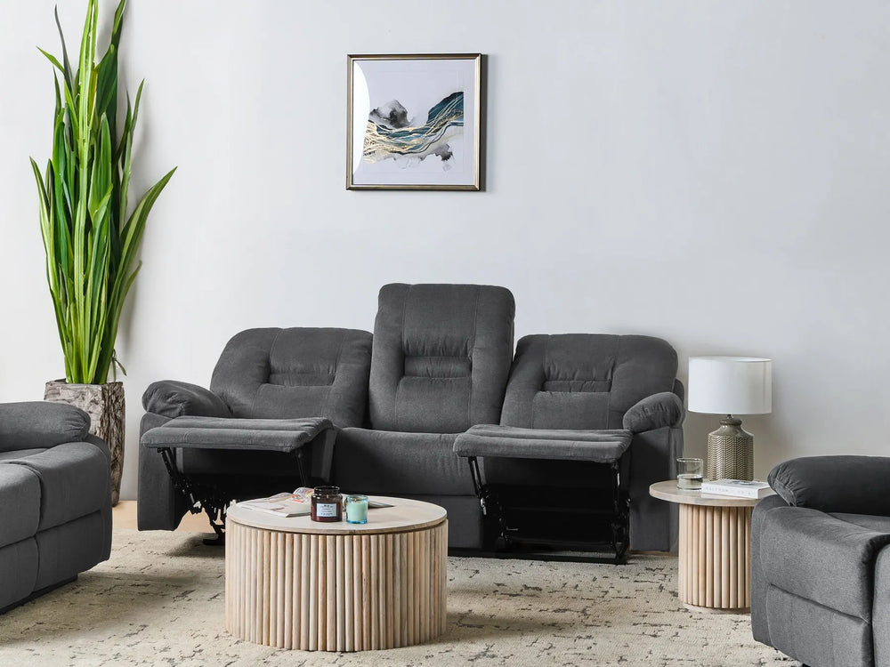Gray sofa set in a living room with a coffee table and decorative items.