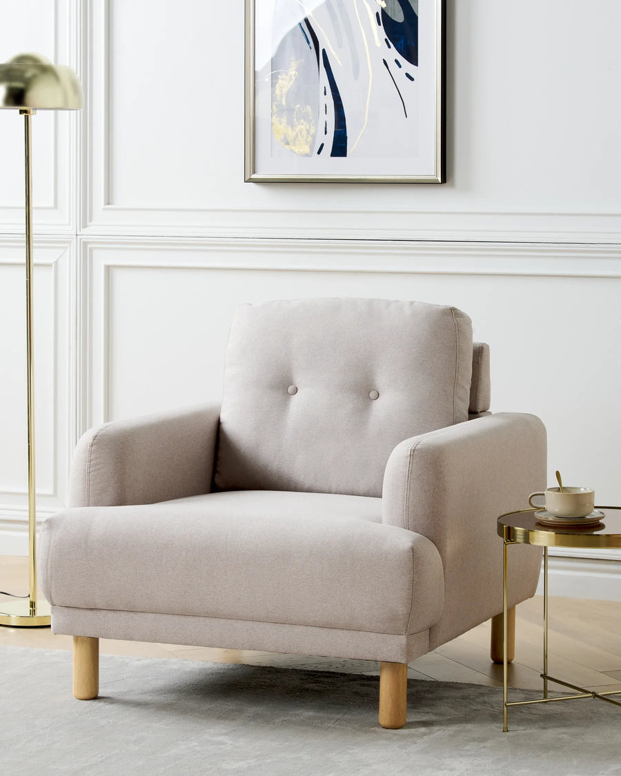 Beige armchair in a modern living room with abstract art on the wall.