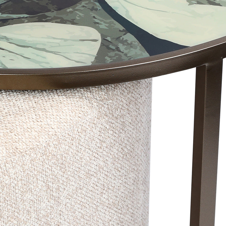 Close-up of a round glass table with a textured surface and metal frame.