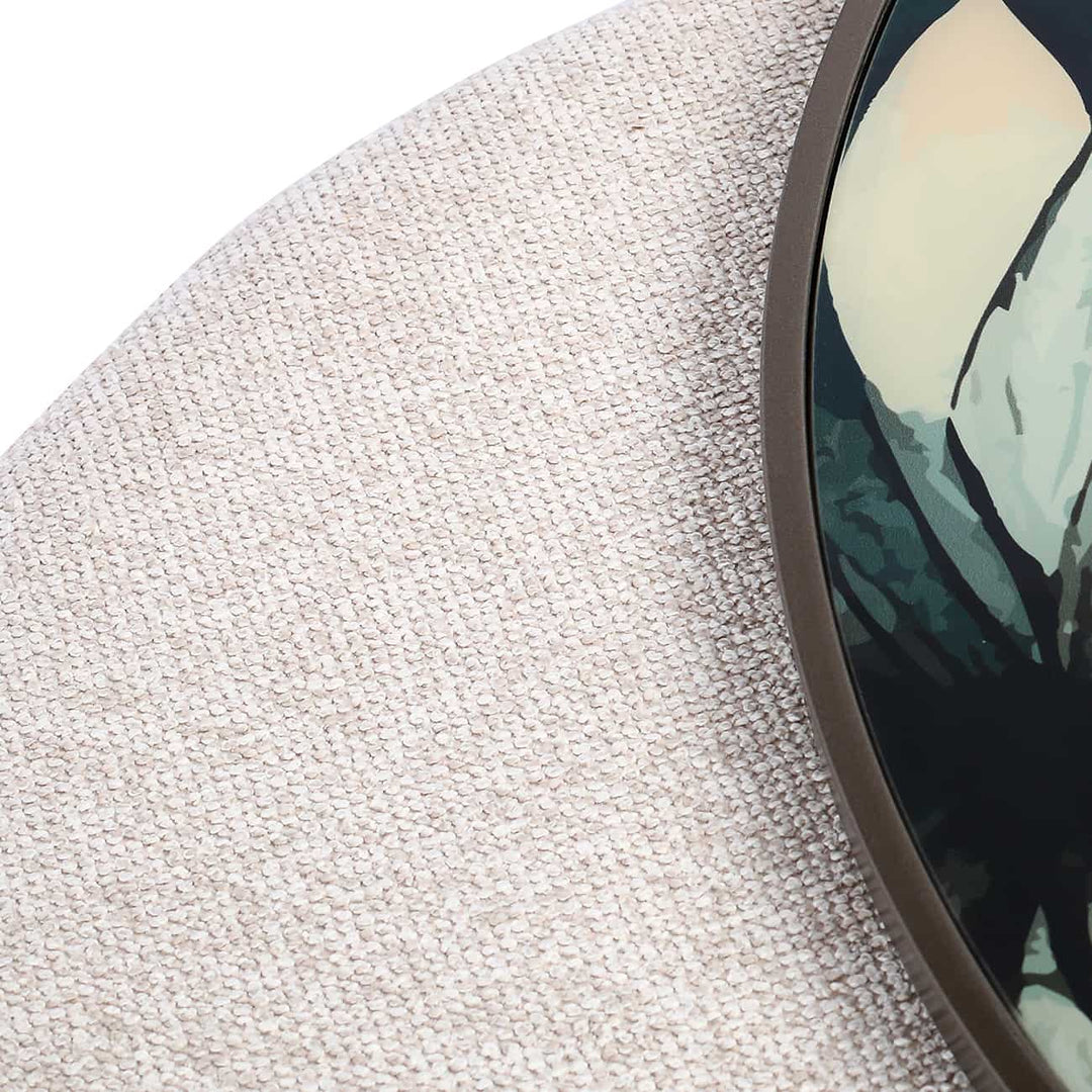 Round coffee table with floral patterned top and textured base 