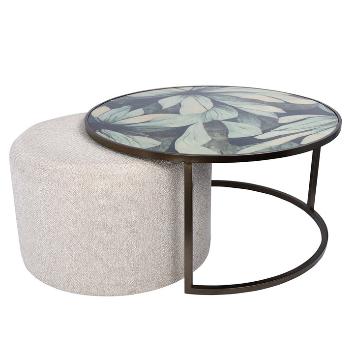 Round coffee table with floral design and white ottoman
