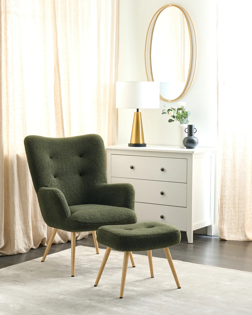 Green armchair with ottoman in a room with curtains and a dresser.