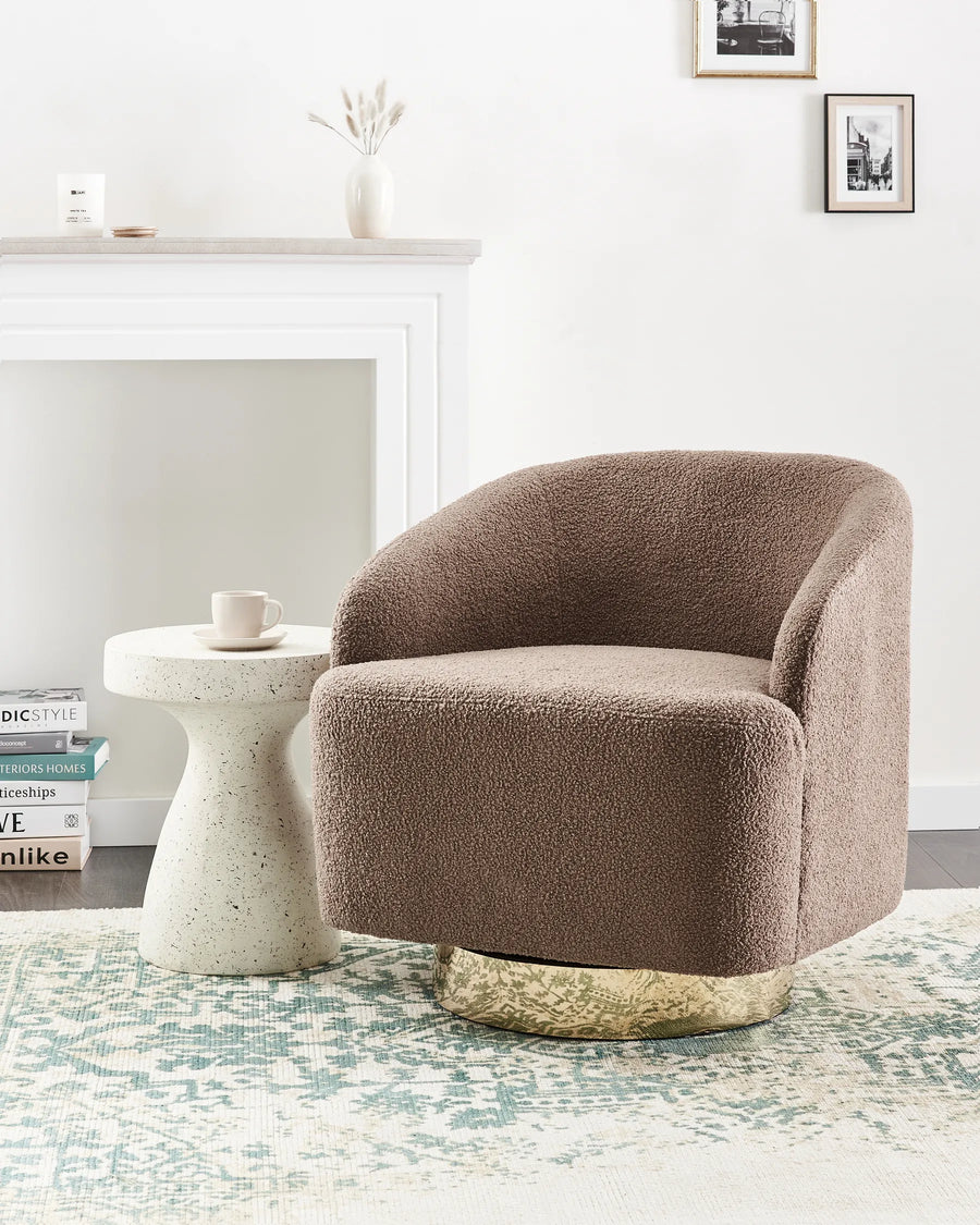 Brown textured armchair in a living room setting with a white fireplace and decorative items.