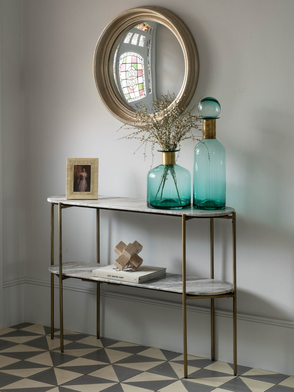Console table with decorative items against a gray wall