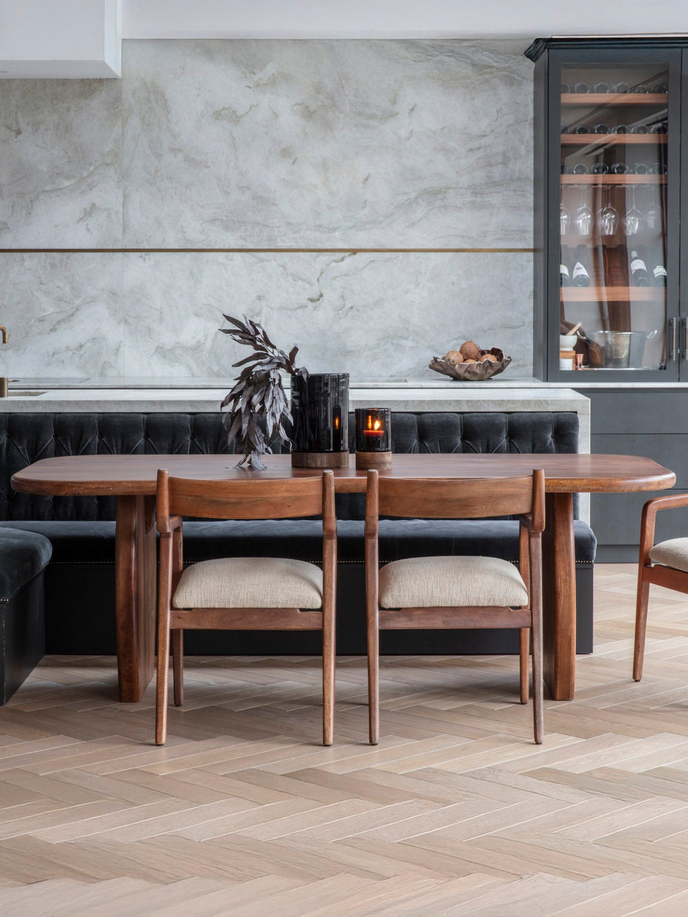 Dining area with wooden table and chairs in a modern kitchen setting.
