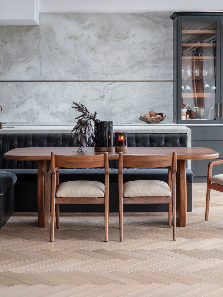 Dining area with wooden table and chairs in a modern kitchen setting.