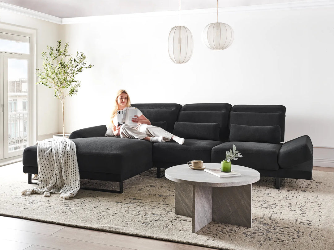 4-seater black L-shaped fabric corner sofa with soft cushions and contemporary design