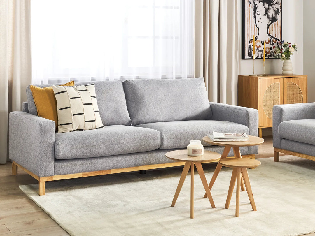 Gray sofa with wooden legs in a living room setting