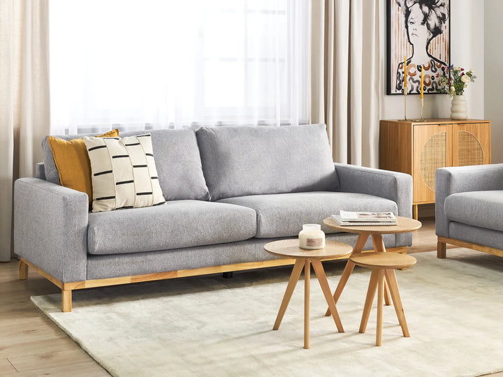 Gray sofa with wooden legs in a living room setting