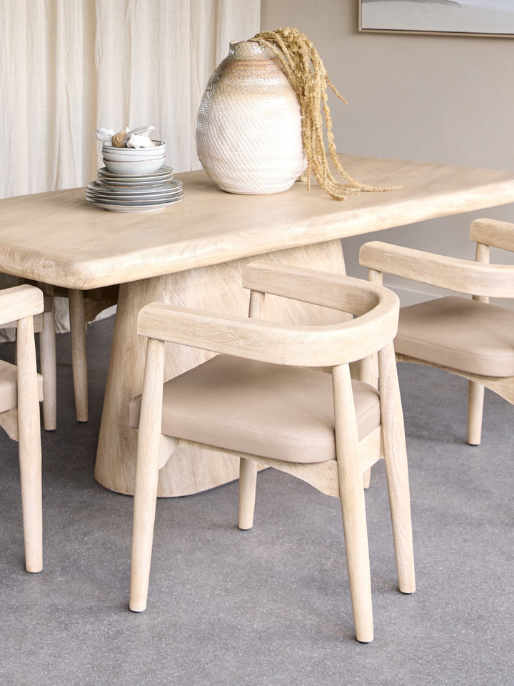 Dining table with chairs in a room setting