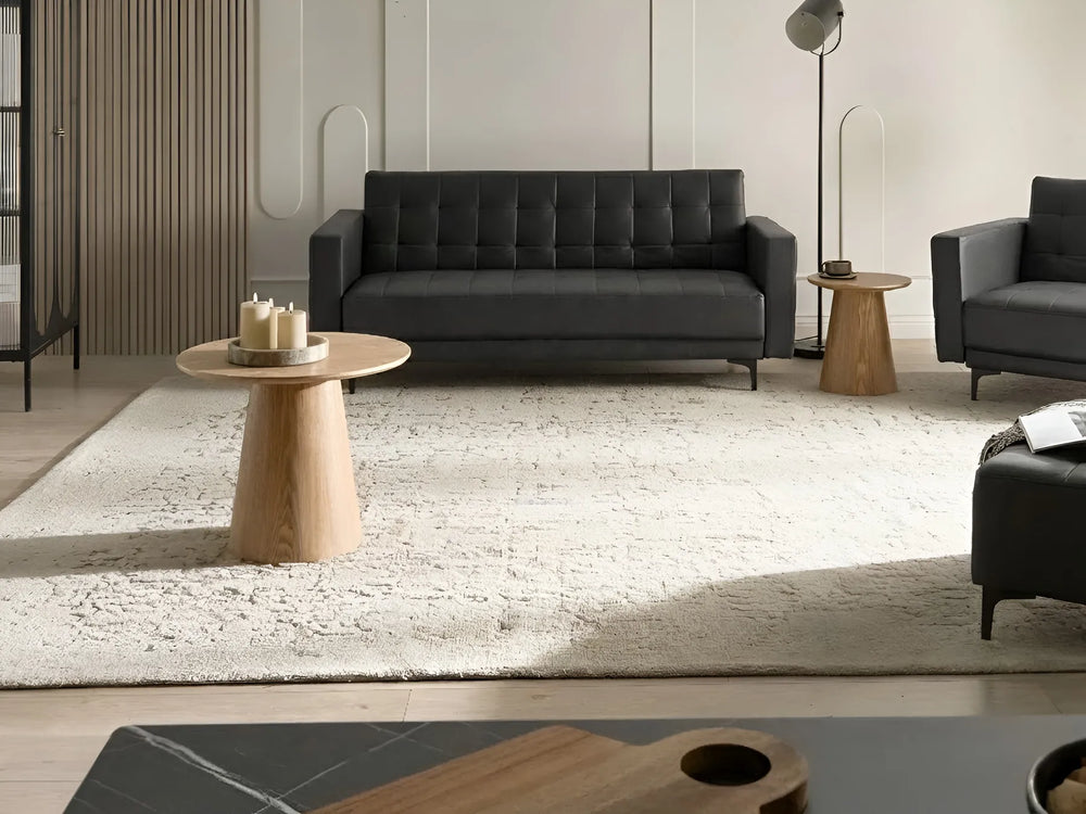 Modern living room with gray sofa, armchair, and wooden coffee table.
