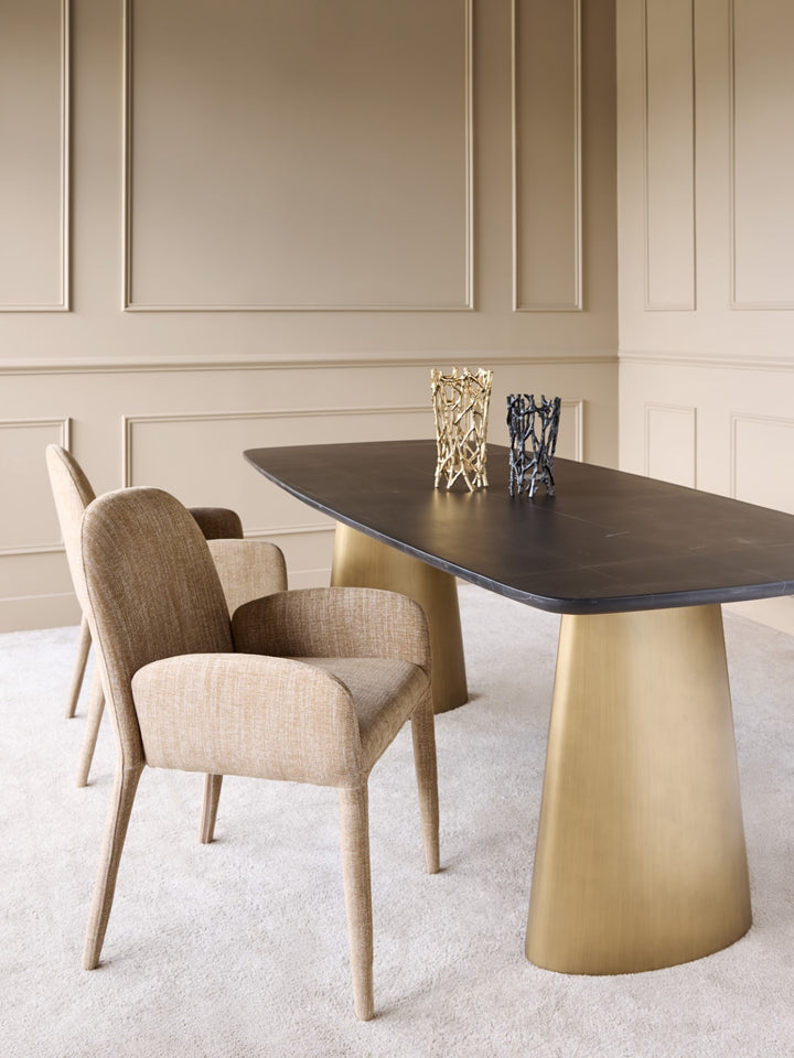 Dining room with a modern table and chairs against a beige paneled wall.
