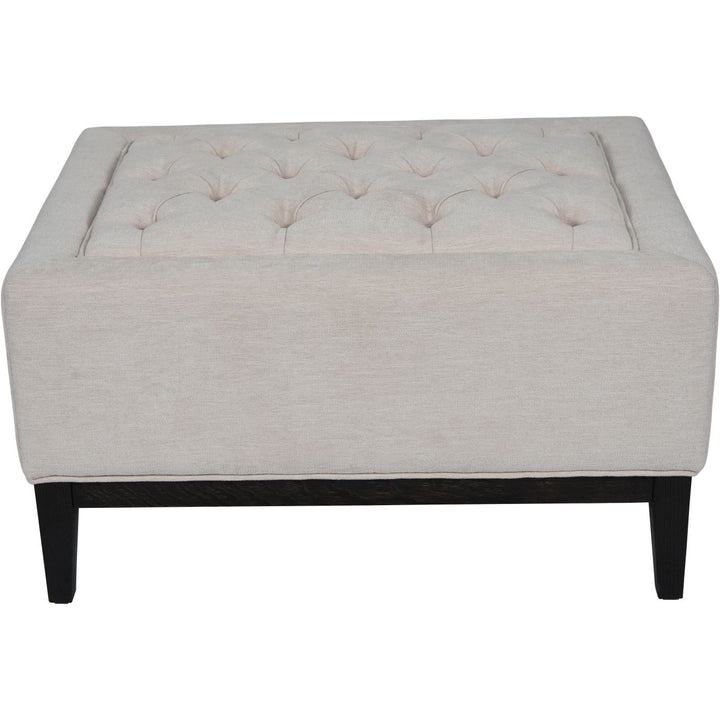 Deep buttoning and tactile woven ivory fabric on Libra Theodore footstool