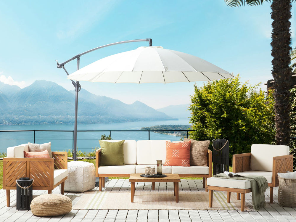 Outdoor patio set with furniture and umbrella overlooking a scenic view.