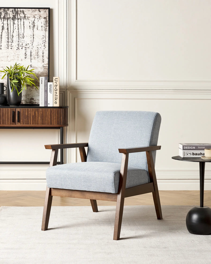 Gray armchair with wooden frame in a living room setting