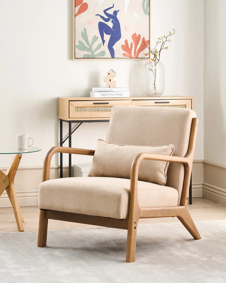 Beige armchair in a room with a small table and decorative items.