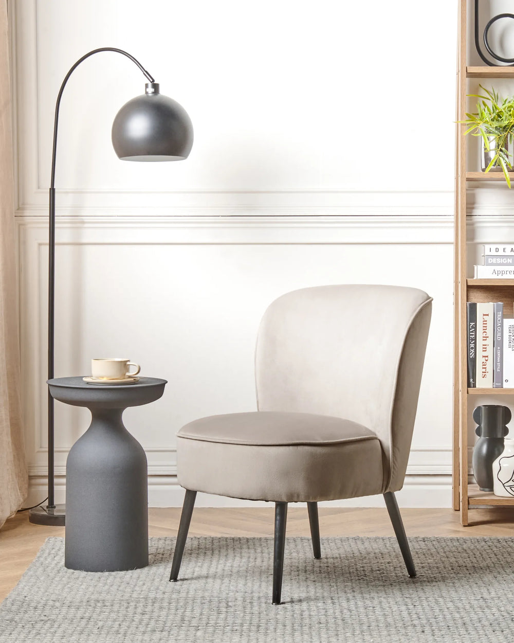 Beige armchair in a modern living room with a floor lamp and side table.