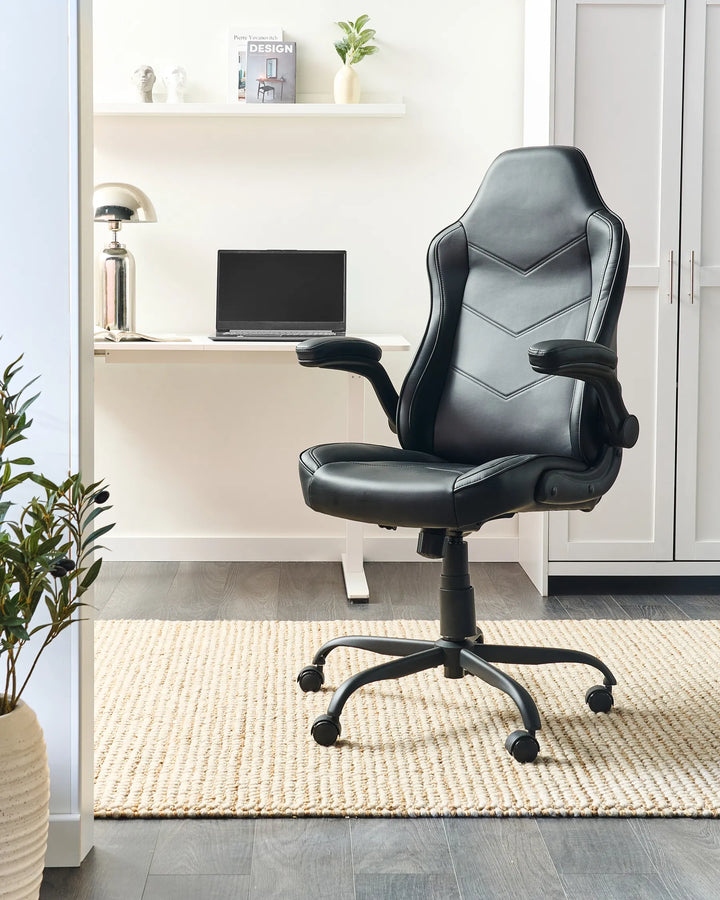 Black office chair in a home office setting with a desk and laptop.