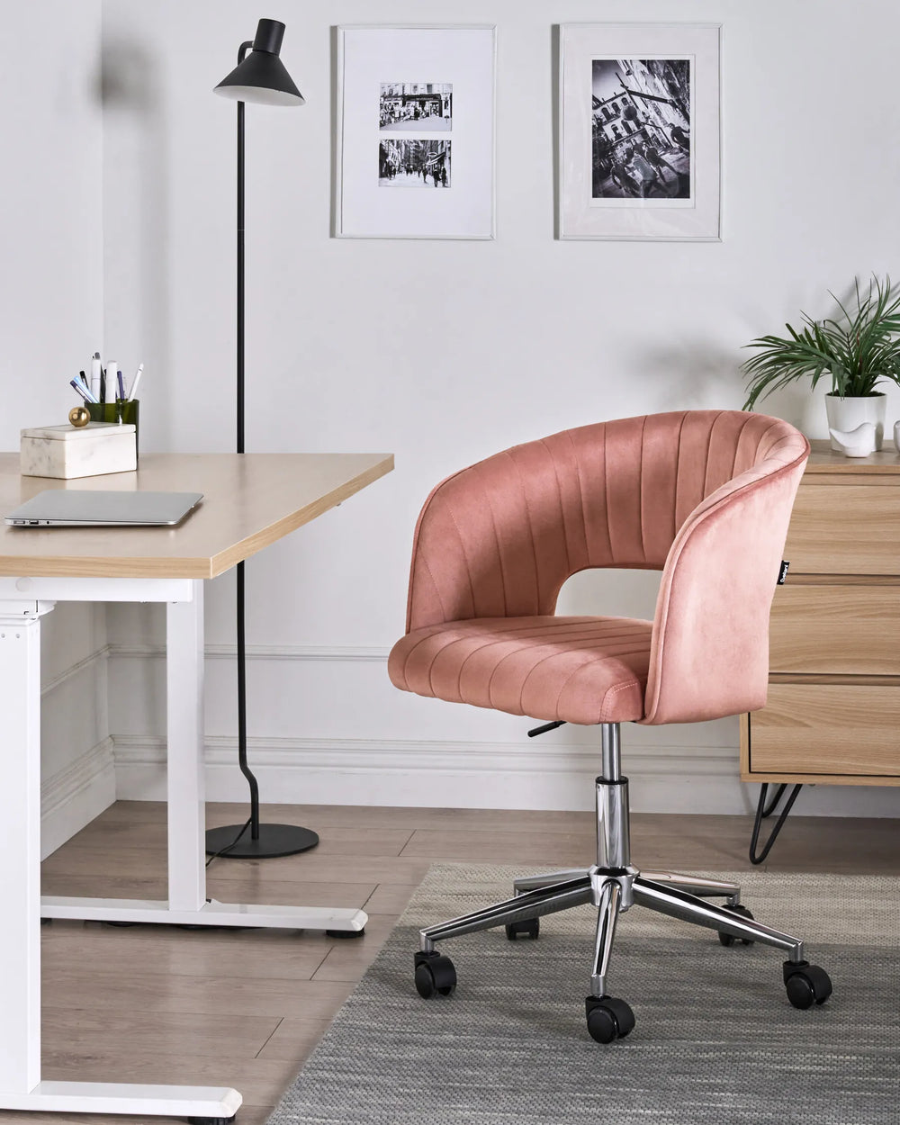 Pink office chair in a modern office setting with a desk and decor.