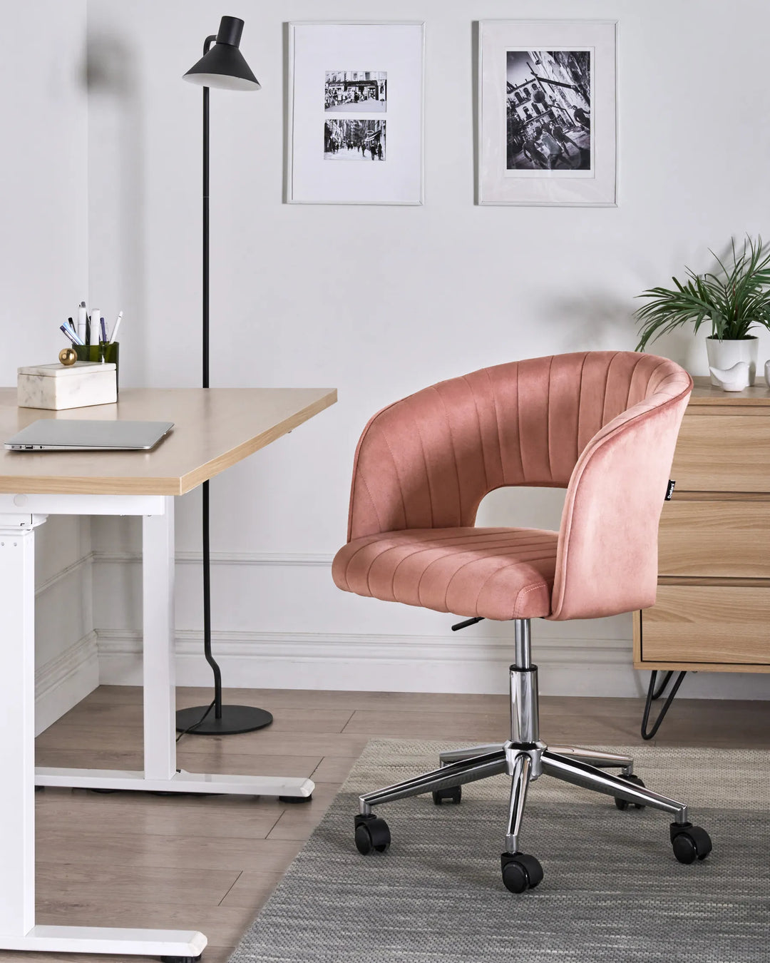 Pink office chair in a modern office setting with a desk and decor.