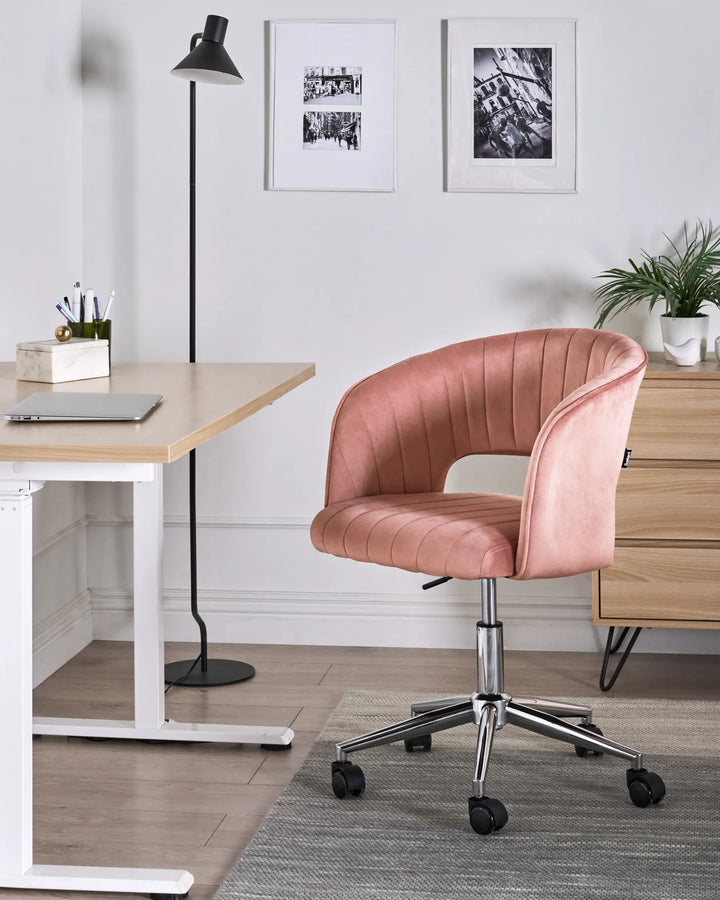 Pink office chair in a modern office setting with a desk and decor.