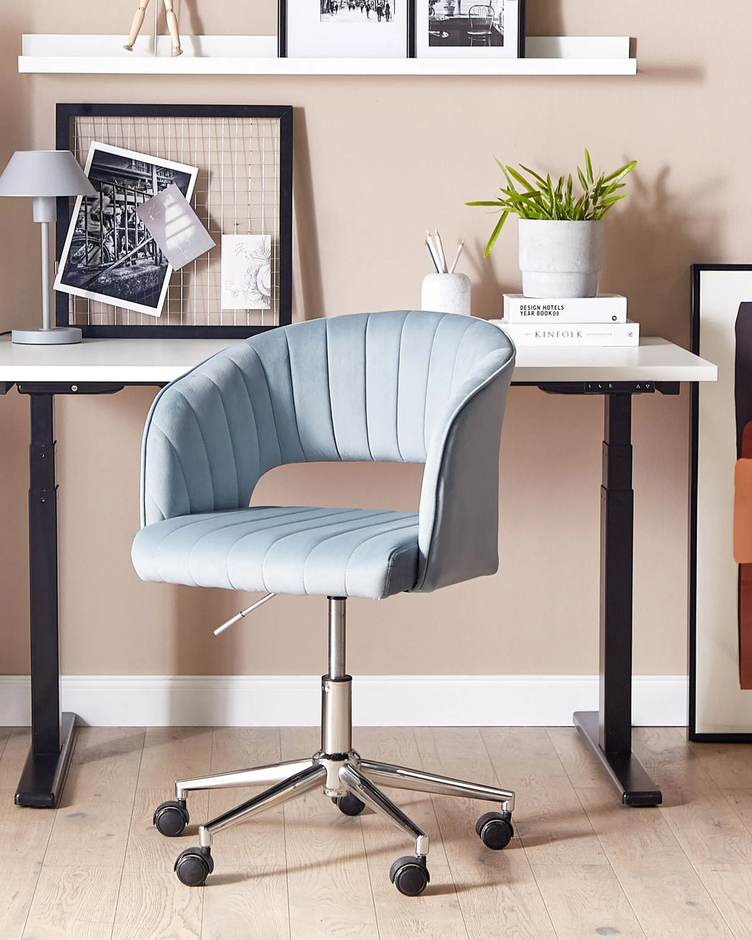 Light blue office chair in front of a desk with decor items.