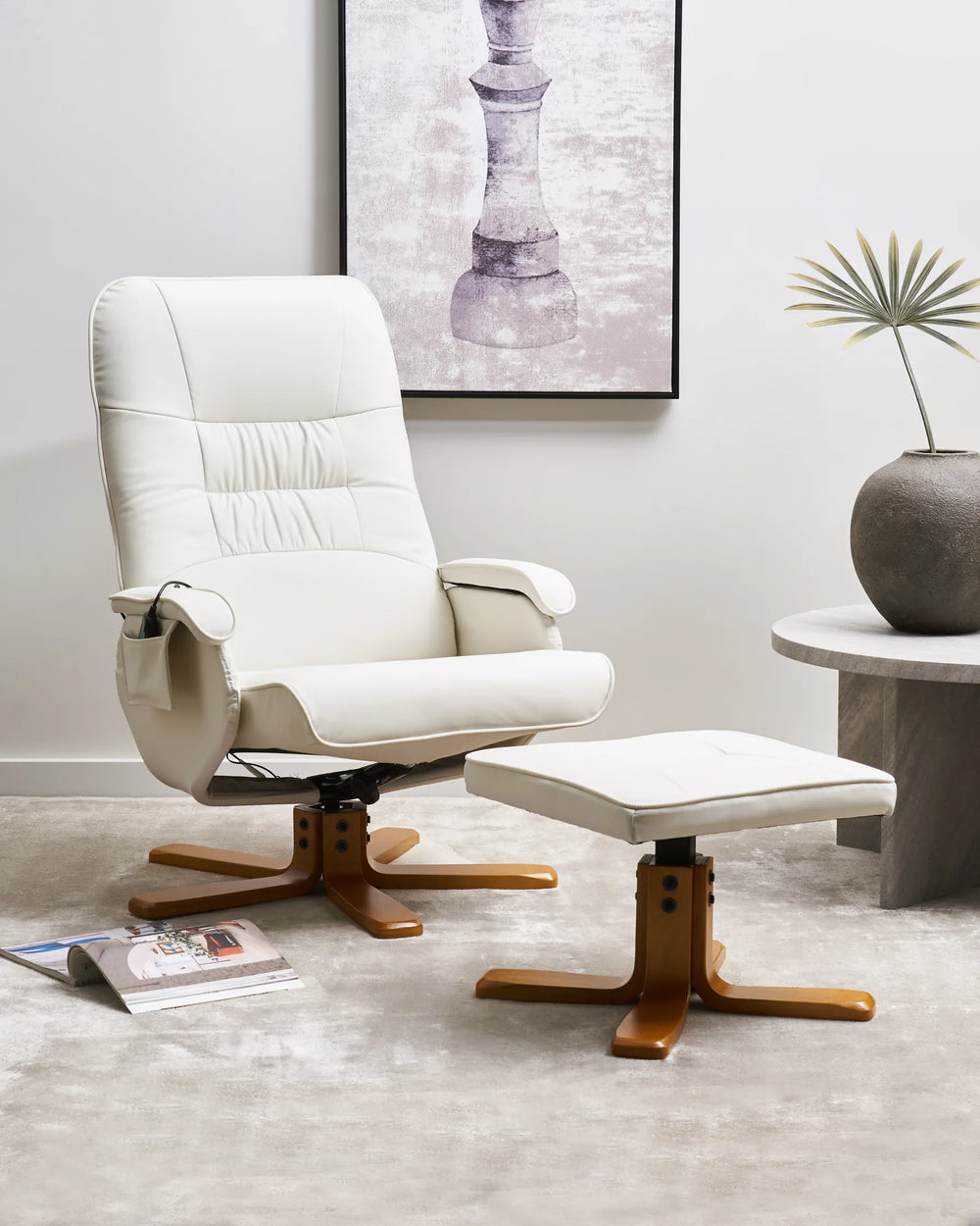 White recliner chair with wooden base in a room with a painting and plant.