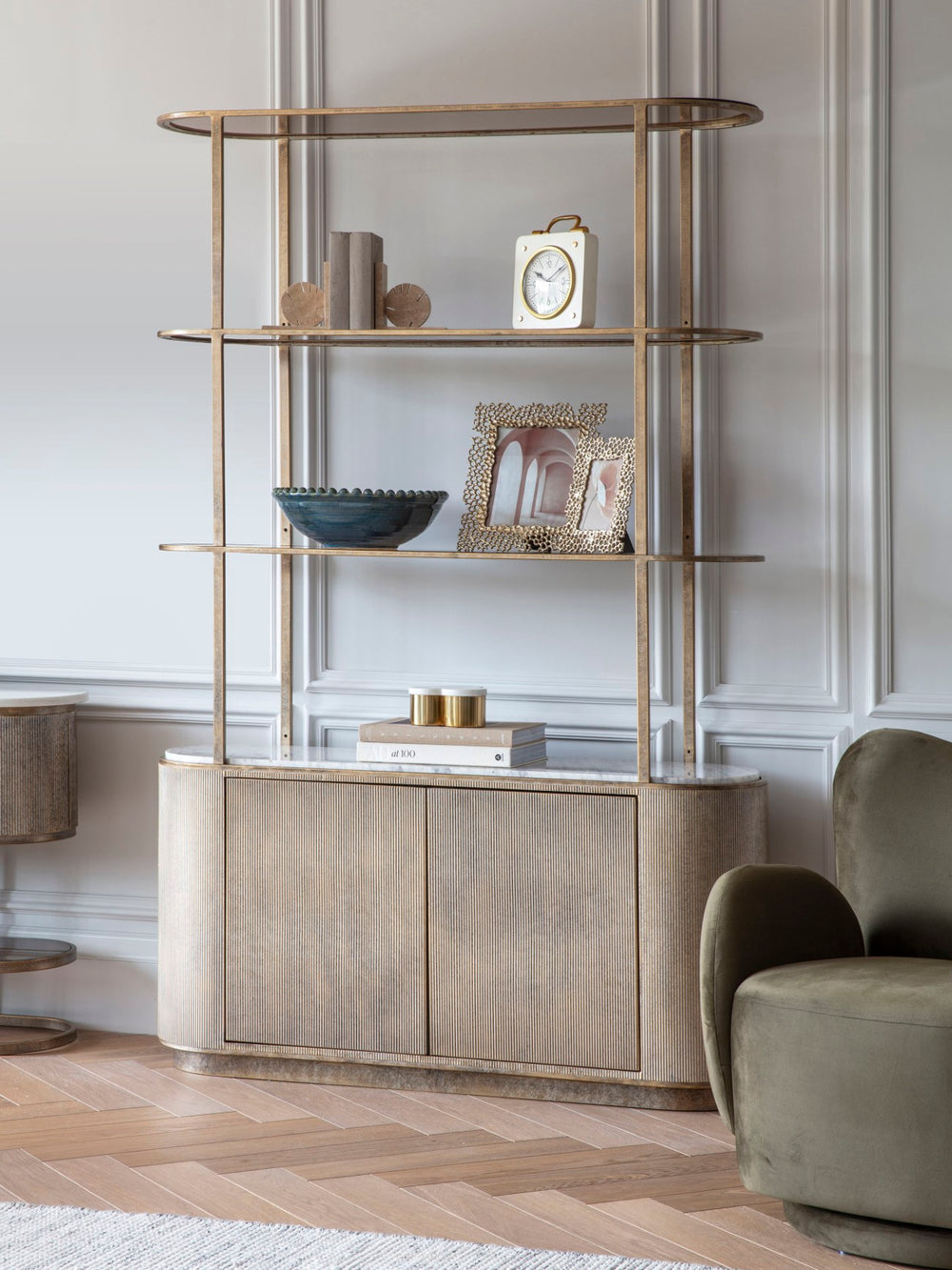 Modern interior with a stylish bookshelf and armchair.