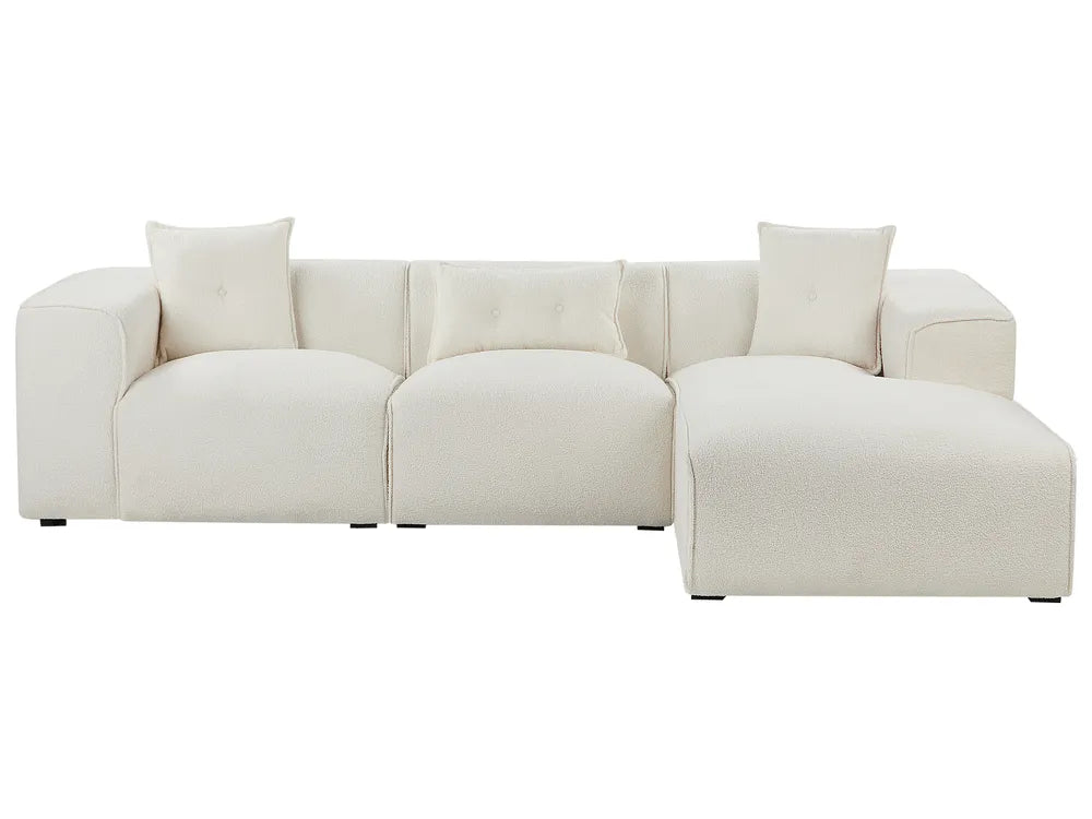 Beige sectional sofa with two cushions on a white background