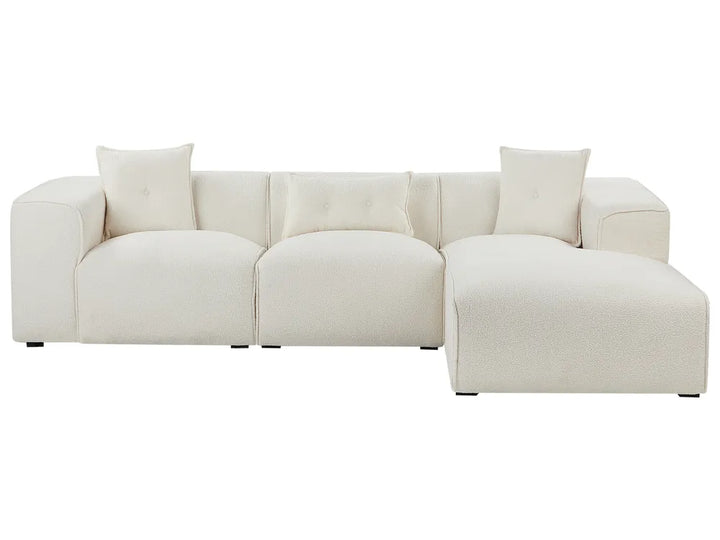 Beige sectional sofa with two cushions on a white background