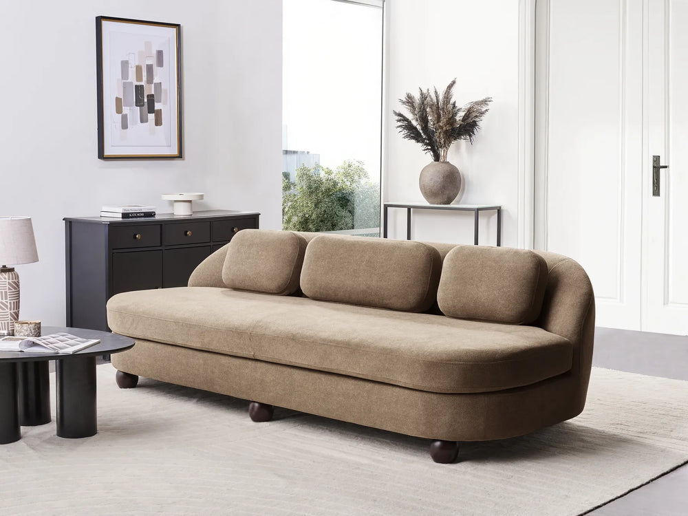 Beige sofa in a modern living room with decor elements.