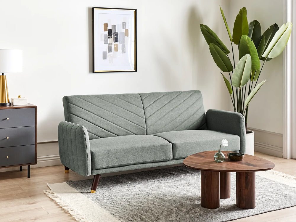 Gray sofa in a living room with a wooden coffee table and decorative items.