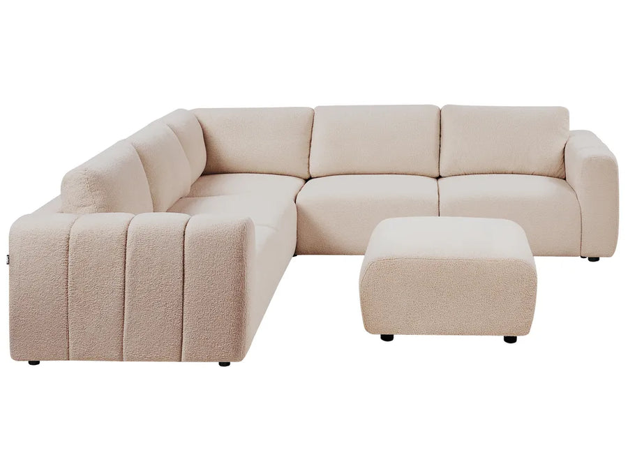 Beige sectional sofa with ottoman on a white background