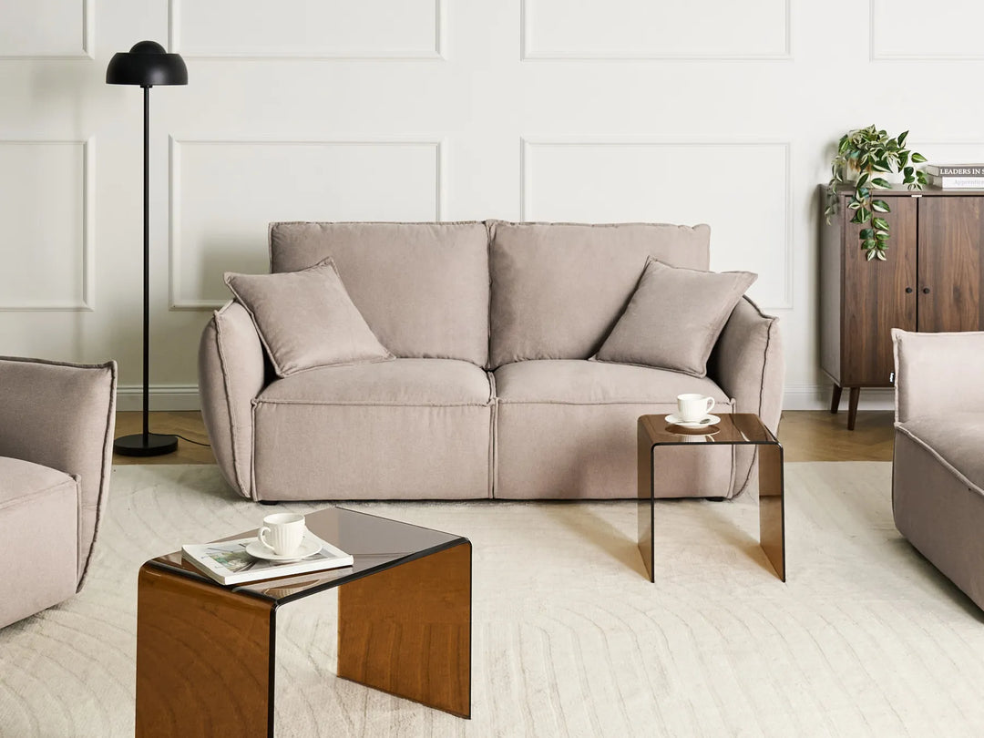 Modern living room with a gray sofa, wooden coffee table, and decorative items.