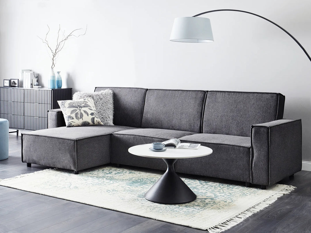 Modern right-hand corner sofa bed in graphite grey fabric with versatile chaise