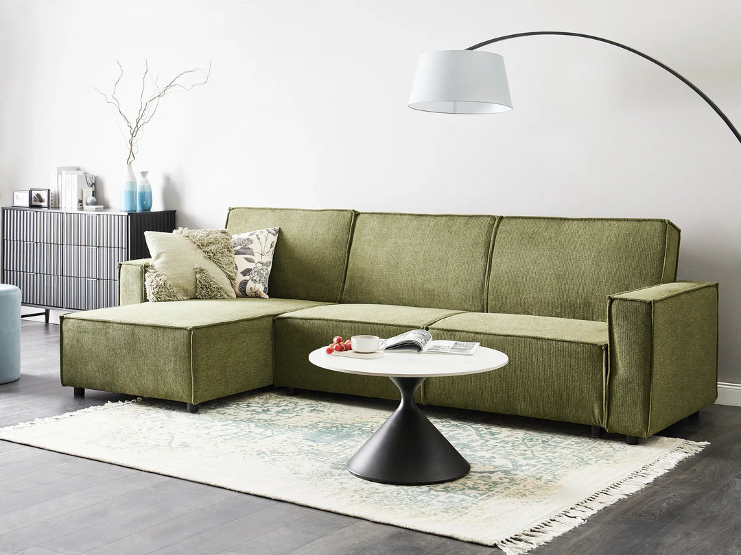 Modern right-hand corner sofa bed in dark green fabric with versatile chaise