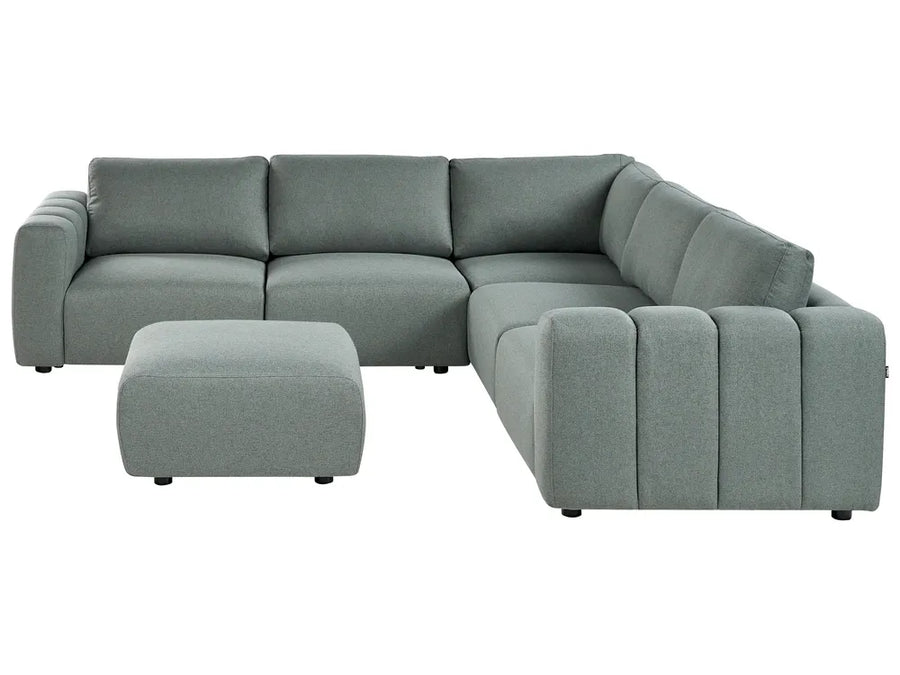 Gray sectional sofa with ottoman on a white background