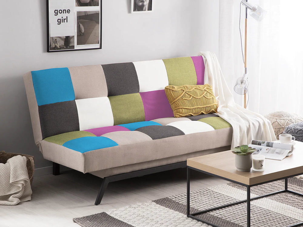 Colorful patchwork sofa in a living room setting with a coffee table and decor items.