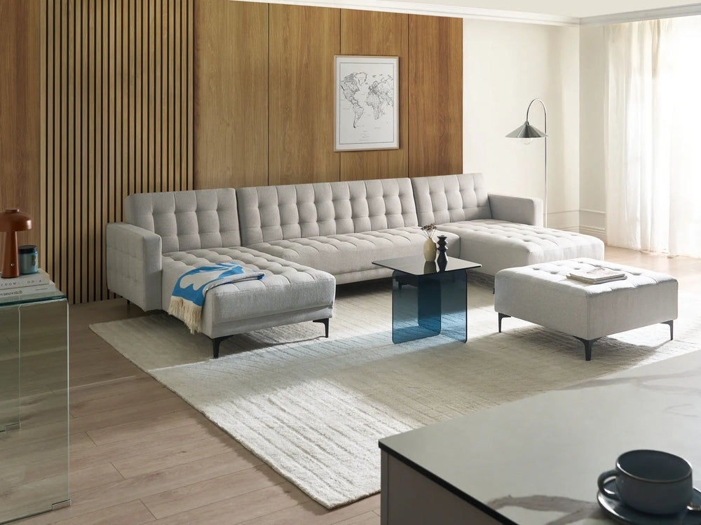 Light grey fabric U-shaped 5-seater modular sofa bed with chaise lounges in a contemporary living room