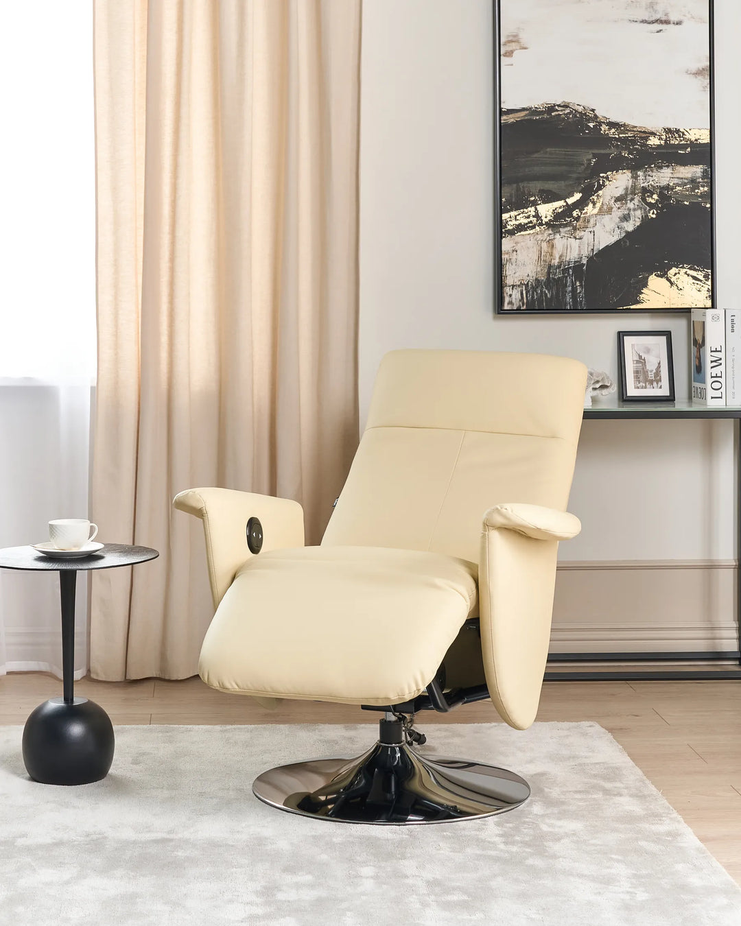 Beige recliner chair in a living room setting with a side table and artwork on the wall.