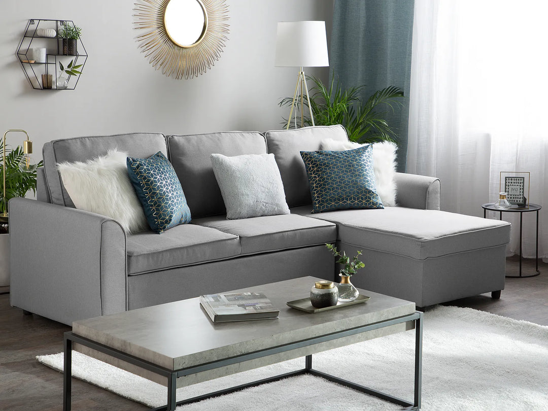 Modern left-hand corner sofa bed in grey fabric with hidden storage compartment
