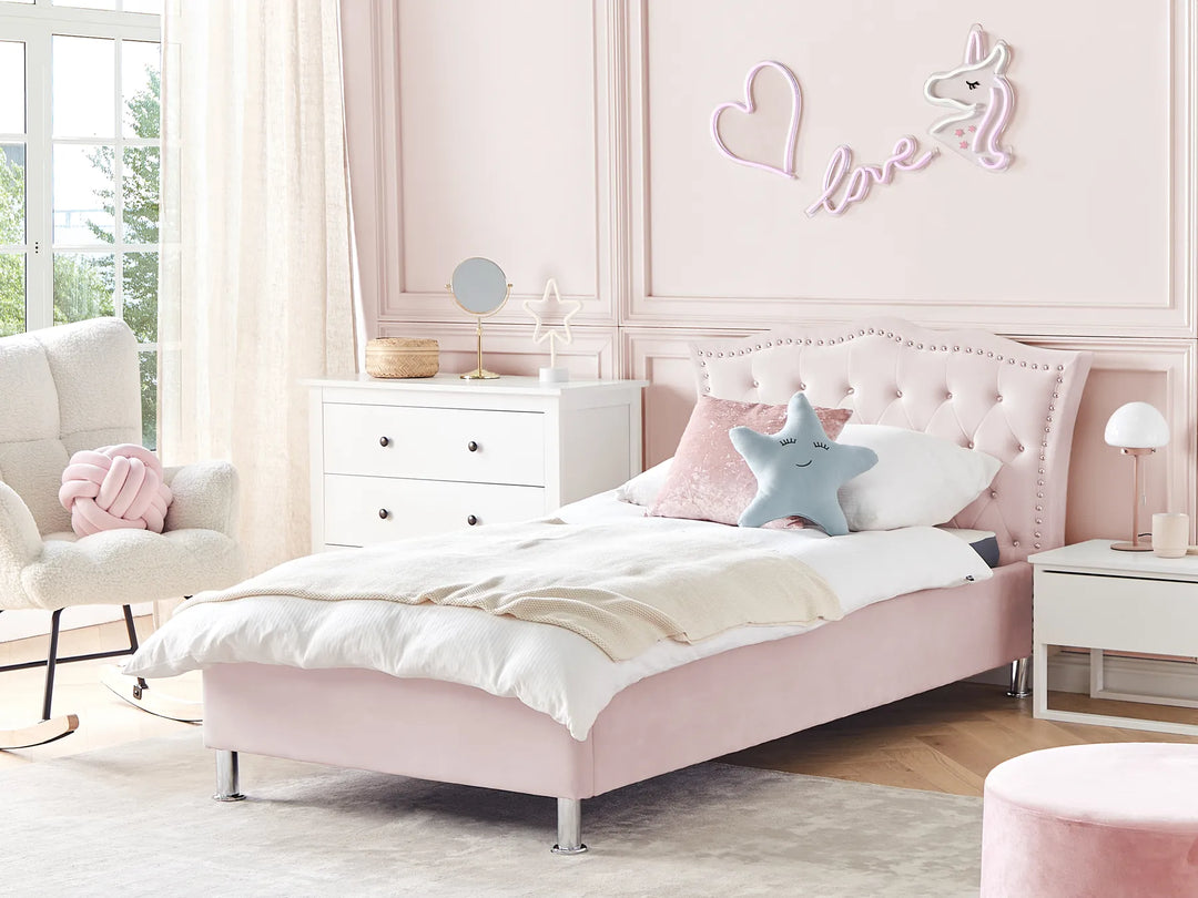 Pink bedroom with a bed, nightstands, and decorative wall art.