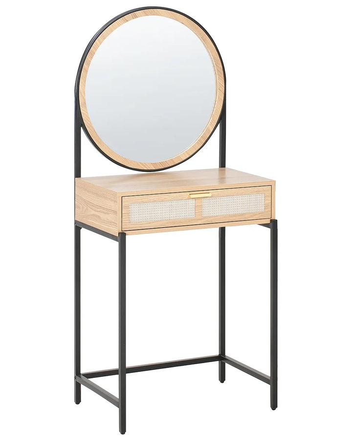 A modern vanity table with a light oak wood top and drawer front, featuring woven cane panels on the drawers and a black metal frame. An oval mirror with a light wood frame is mounted on the backrest, which is supported by slim black metal legs.