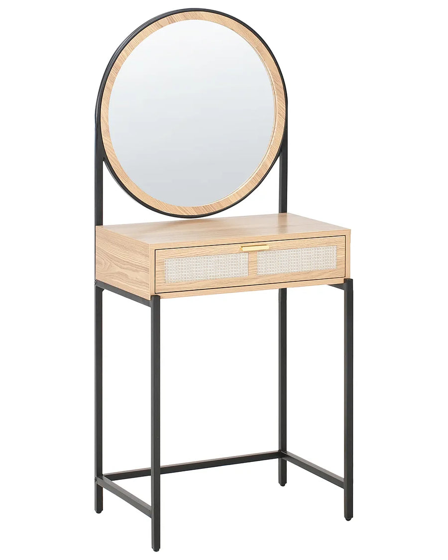 A modern vanity table with a light oak wood top and drawer front, featuring woven cane panels on the drawers and a black metal frame. An oval mirror with a light wood frame is mounted on the backrest, which is supported by slim black metal legs.