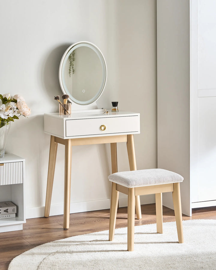 Dresser with round mirror and stool in a room setting