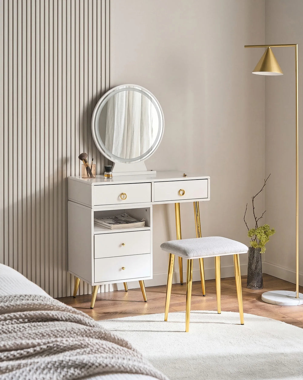 White vanity with round mirror, drawers, and stool in a bedroom setting.