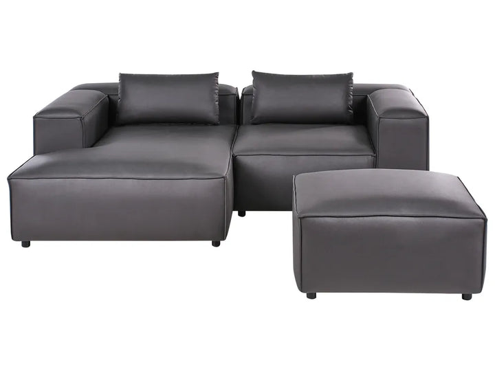 Gray sectional sofa with ottoman on a white background