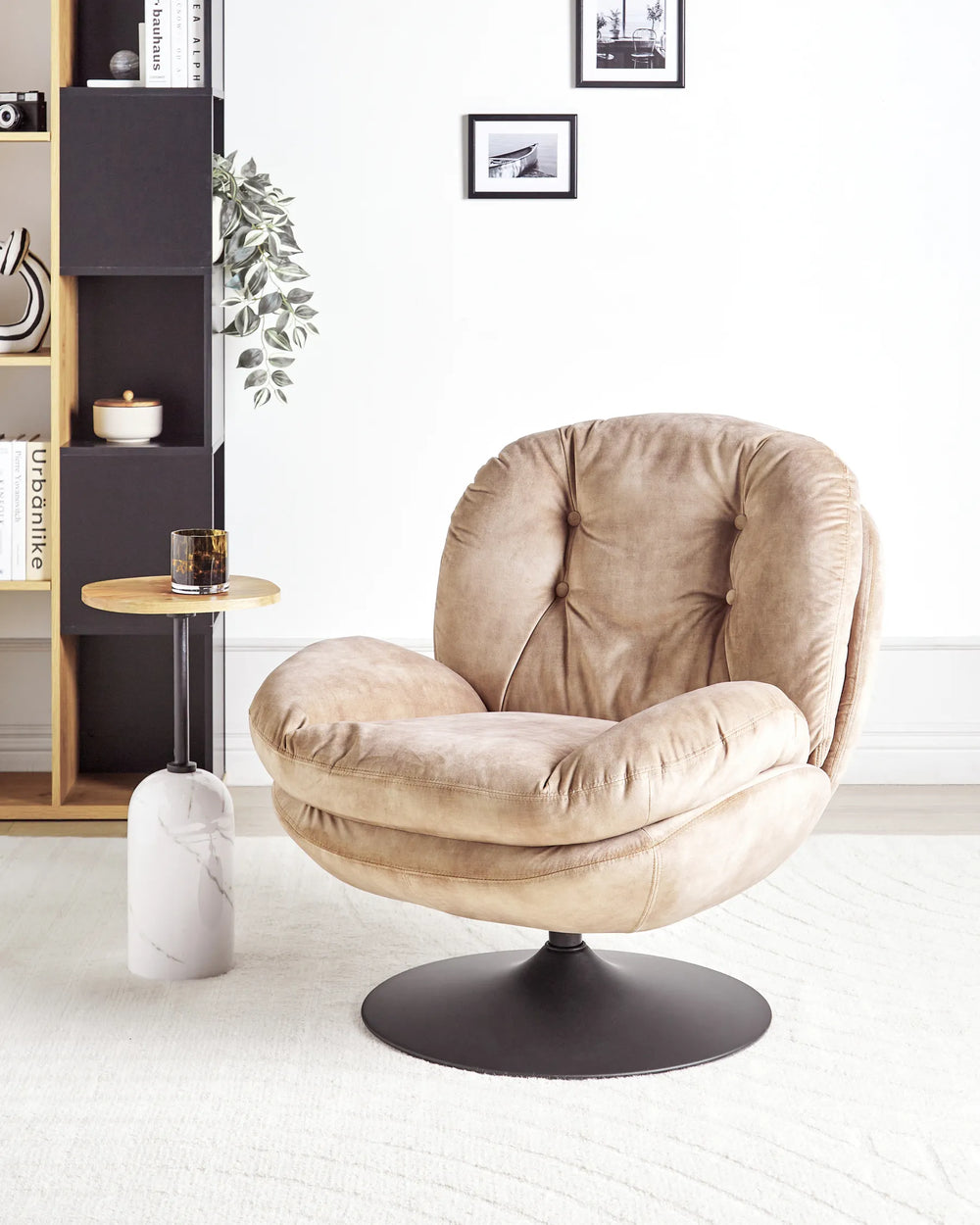 Beige armchair in a modern living room setting with a bookshelf and small table.