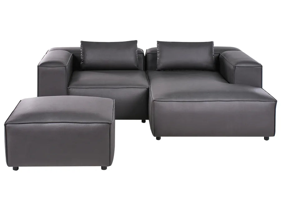 Gray sectional sofa with ottoman on a white background